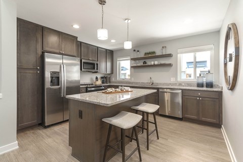 a kitchen with stainless steel appliances and a marble counter top